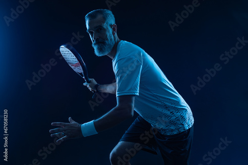Padel tennis player in social media template. Man athlete with paddle tenis racket on blue background. Social media ads mockup. Thumb up. © Mike Orlov