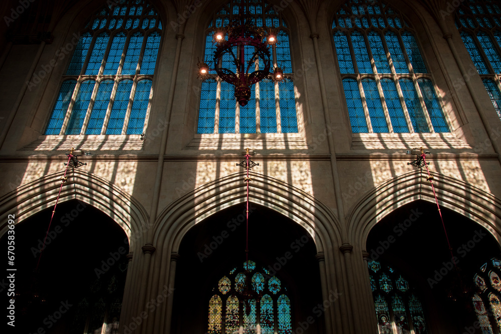 Inside of the Bath Abbey with gothic architectural style. Famous cathedral in England. High church windows with lights and shadows. Christian chapel interior building in United Kingdom