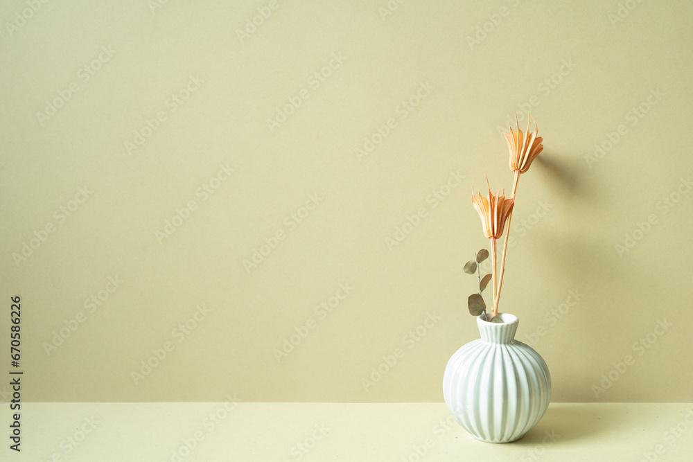 Vase of dry flower on table. khaki beige background