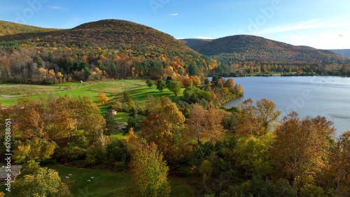 Mountain, trees and fields in sunny landscape with campground and outdoor park in Autumn Fall Colors in Tioga, Pennsylvania Ives Run Campground