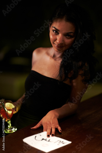 Woman, call me and flirt with lipstick on napkin, seduce and sexy or message for bartender. Brazilian female person, alcohol and drunk or tipsy, outdoors and smiling at night, event and party
