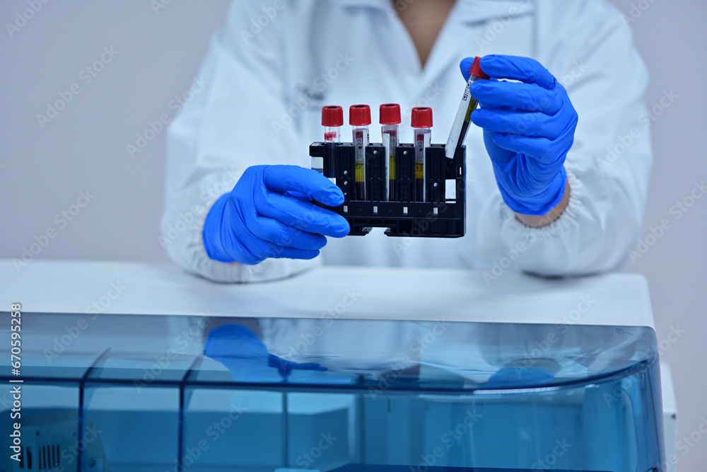 Female medical technologist using diagnostic equipment in cancer hospital lab in Asia Female medical technologist using diagnostic equipment in cancer hospital lab in Asia
