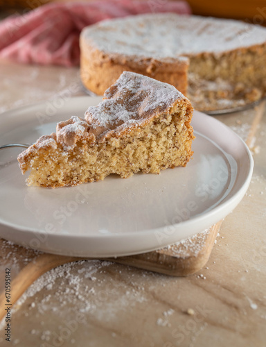 Slice of gluten free almond cake on wooden table