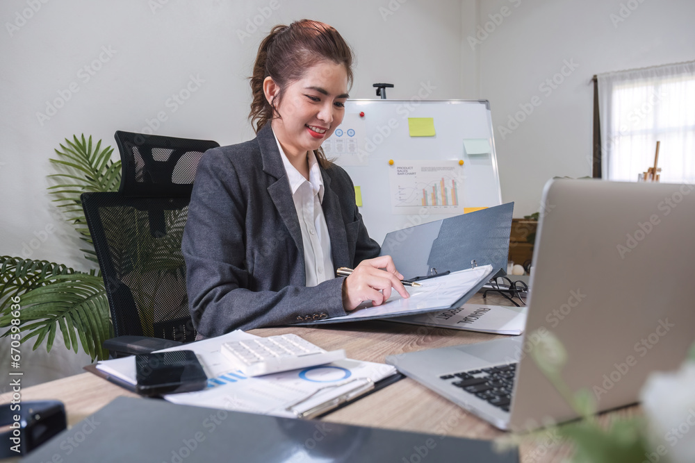 Business woman using calculator for do math finance on wooden desk in office and business working background, tax, accounting, statistics and analytic research concept Business woman using calculator for do math finance on wooden desk in office and business working background, tax, accounting, statistics and analytic research concept