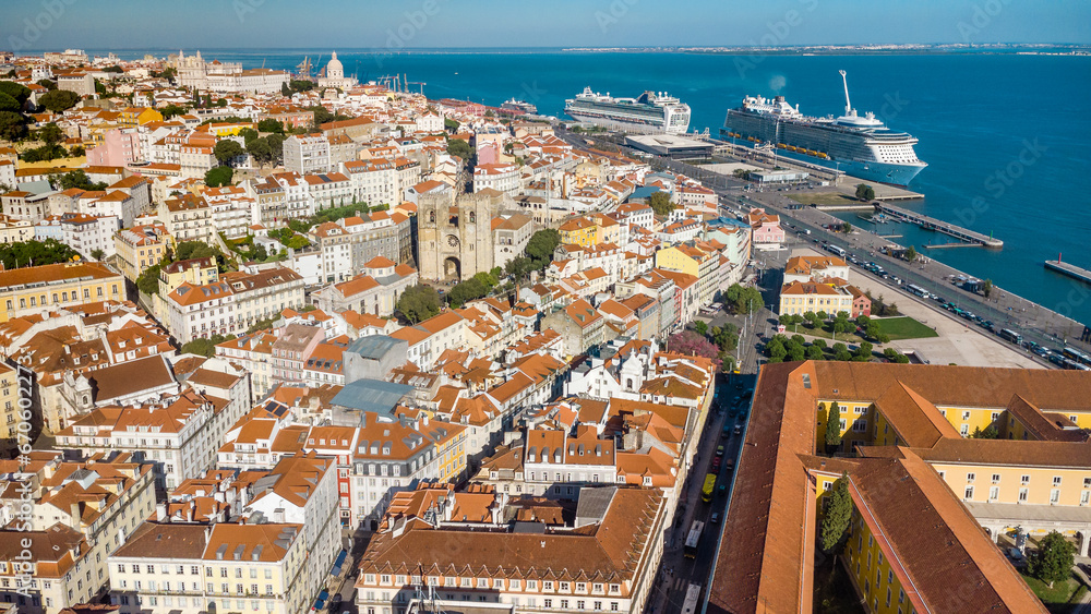 Aerial view of Lisbon. Rooftops of Lisbon. In background, view of Cruise Ship Terminal of Lisbon. Two cruise ships docked in the port. Beautiful promenade of Lisbon. Travel destination