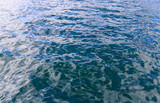Small ripples reflect morning sun on calm ocean water
