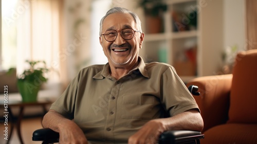 Elderly man sitting in wheelchair smiling looking at camera in living room at home