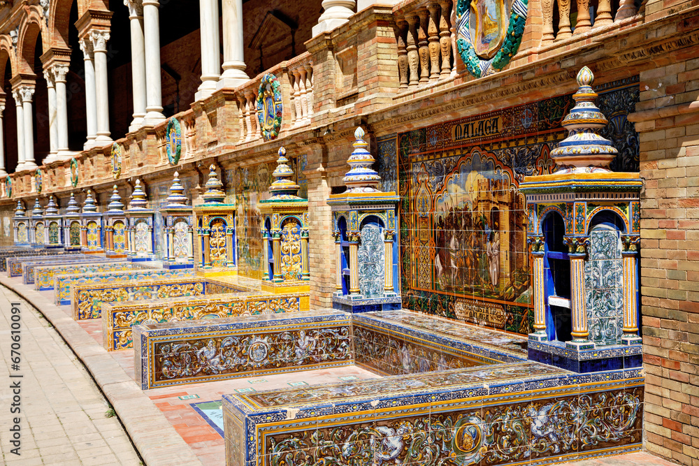 SEVILLE, SPAIN - 13 APRIL, 2023: The tiled Provincial Alcoves along the walls of the Plaza de Espana in Seville, a big tourist centre in Spain