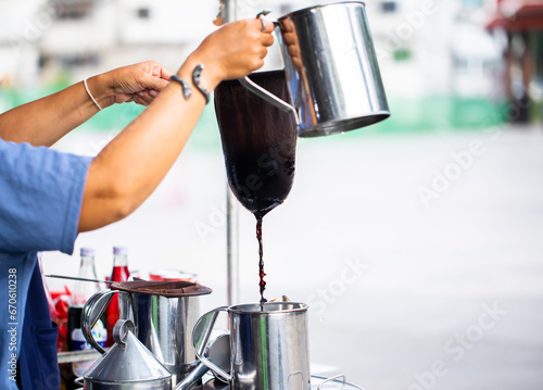 Thai woman make a cup of coffee is a traditional. photo