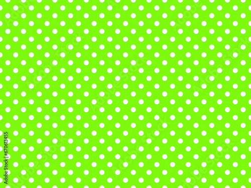 texturised white color polka dots over chartreuse green backgrou