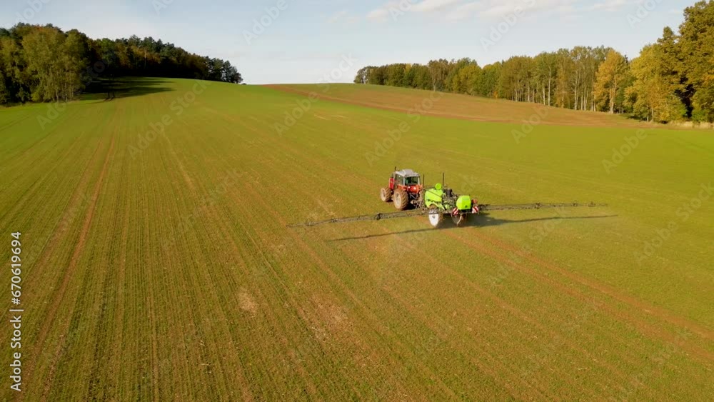 A tractor in a field that fertilizes the soil. Autumn in Lower Silesia, Poland. A tractor in a field that fertilizes the soil. Autumn in Lower Silesia, Poland.
