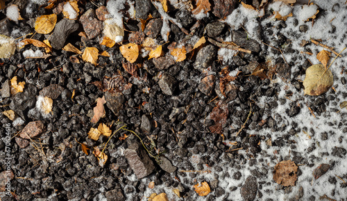 Asphalt texture with leaves and snow