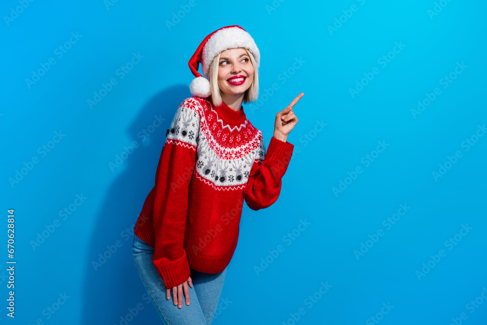 Obraz premium Photo of pretty dreamy lady santa helper dressed ornament sweater looking showing finger empty space isolated blue color background