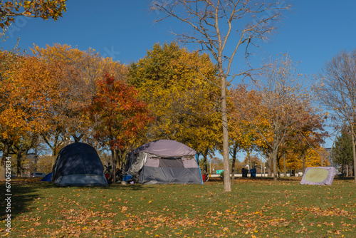 Homeless people shelter tents encampment in downtown city park in Toronto, Canada. Homelessness, inequality, injustice, poverty and social issues concept.