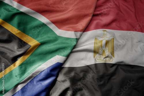 big waving national colorful flag of south africa and national flag of egypt .