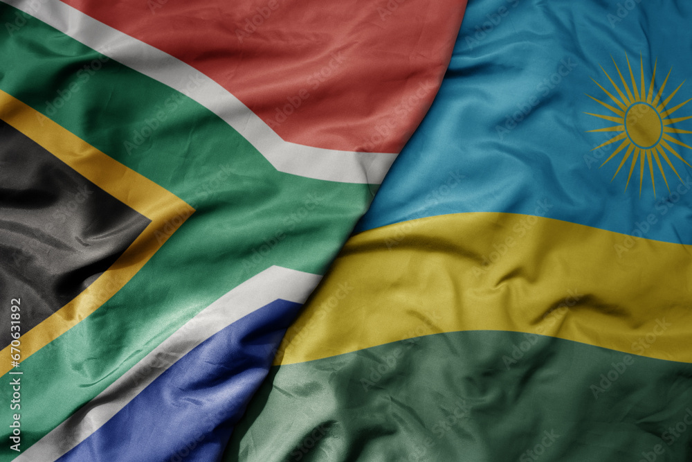 big waving national colorful flag of south africa and national flag of rwanda . big waving national colorful flag of south africa and national flag of rwanda .