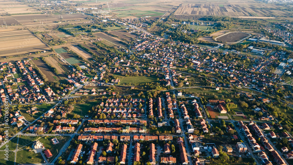 Aerial view of suburban houses in new modern development area. Small city on aerial view. Scenic seasonal landscape from above aerial view of a small town in countryside Pancevo, Serbia