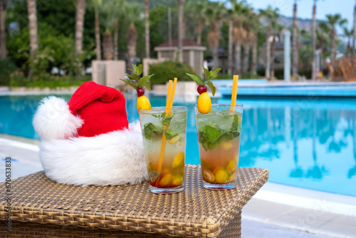 Santa's hat near the pool with cocktails