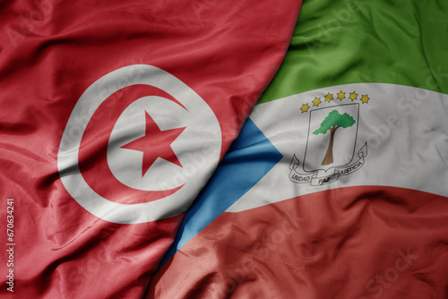 big waving national colorful flag of tunisia and national flag of .