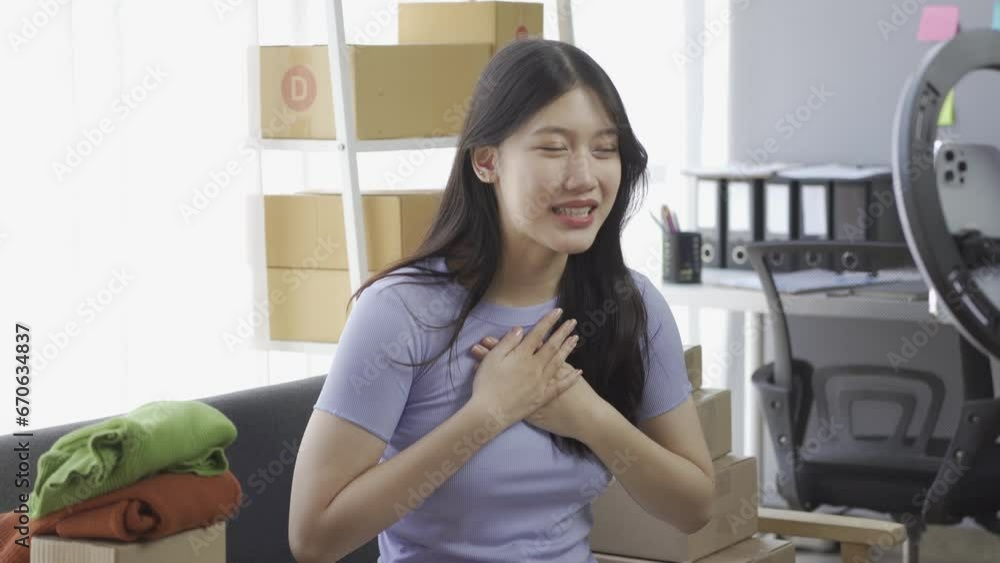 Asian girl selling clothes online using laptop at apartment, fashion blogger records video for online blog, cute woman in live broadcast on internet clothing store at home Asian girl selling clothes online using laptop at apartment, fashion blogger records video for online blog, cute woman in live broadcast on internet clothing store at home