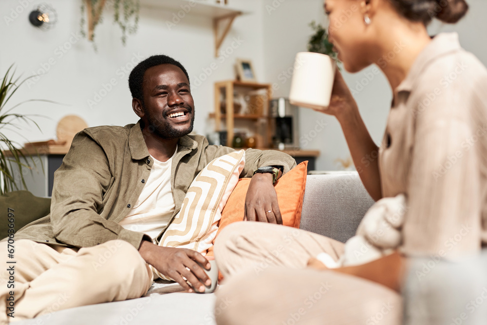 Portrait of young African American couple talking joyfully in morning in cozy home, everyday life - obrazy, fototapety, plakaty 
