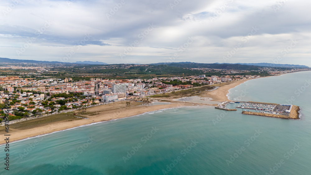 Aerial drone photo of the coastline and town centre of Comarruga in Spain