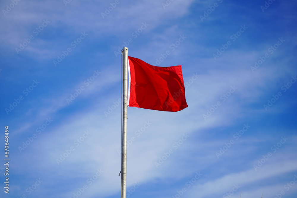 Red flag surf warning sign on beach Red flag surf warning sign on beach