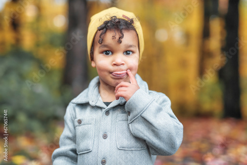 two year old little boy posing in autumn park