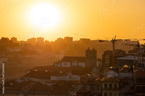 The sun sets  casting warm hues over a picturesque cityscape