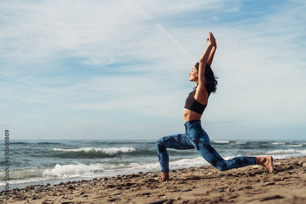 Beautiful athletic brunette girl doing Pilates by the seaside Beautiful athletic brunette girl doing Pilates by the seaside