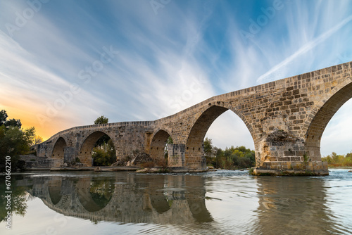 The historical Aspendos Bridge over Koprucay at sunrise in Antalya Turkey photo