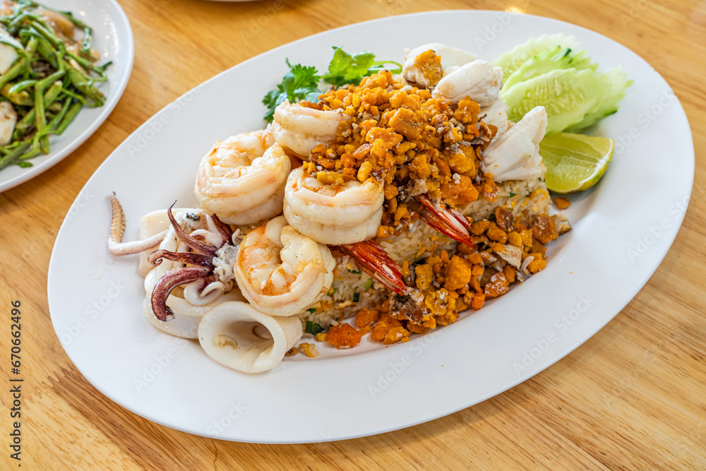 Delicious seafood thai fried rice (crab meat, shrimp, crab roe and squid)