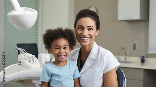 Smiling dentist and a small child at a dental clinic appointment