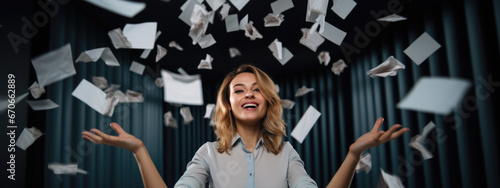 Happy businesswoman throwing papers in the air as a sign of victory and success in her work photo