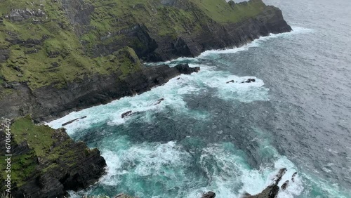 Scenic view of famous Kerry cliffs (Aillte Chiarrai) and Puffin island. Irish coastal nature. Motion of big Atlantic ocean waves. Camera motion. Kerry Cliffs viewpoint, Kerry, Ireland photo