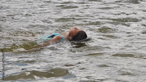 Girl peeping from lake surface at summer nature closeup. Enjoy holidays and summer