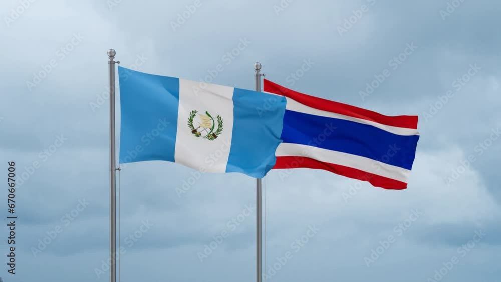 Kingdom of Thailand and Guatemala flag waving together on cloudy sky, endless seamless loop, two country cooperation concept Kingdom of Thailand and Guatemala flag waving together on cloudy sky, endless seamless loop, two country cooperation concept