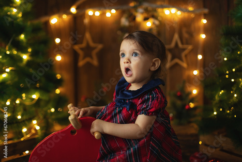 Young girl in beautiful dress at decorated room celebrate Christmas and New Year. 