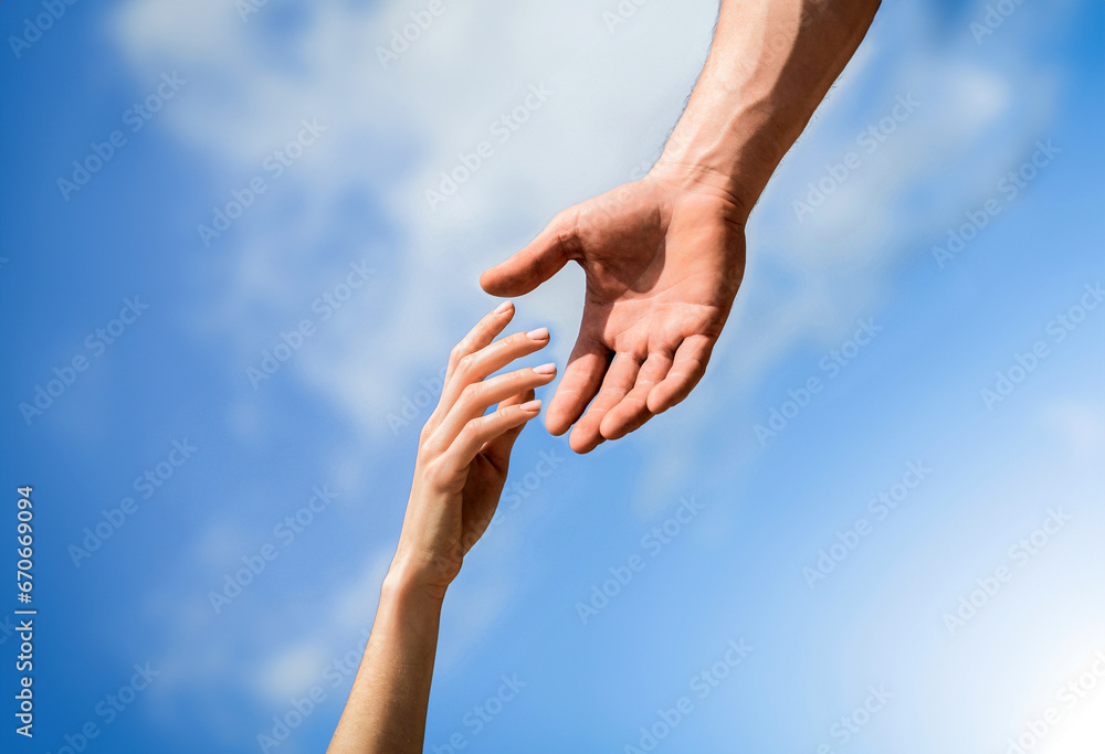 Giving a helping hand. Hands of man and woman reaching to each other, support. Rescue, helping gesture or hands. Lending a helping hand. Solidarity, compassion, and charity, rescue