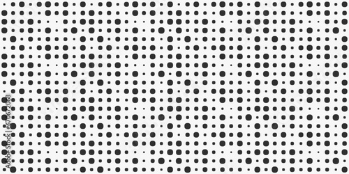 A grid of different sized dots. Black shapes are arranged in a grid on a white background.