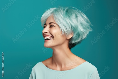 Beautiful and stylish young woman with a cheerful smile and a fashionable look in a close-up portrait on a blue background.