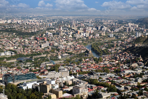 Aerial view of a large modern city with skyscrapers and a river. photo