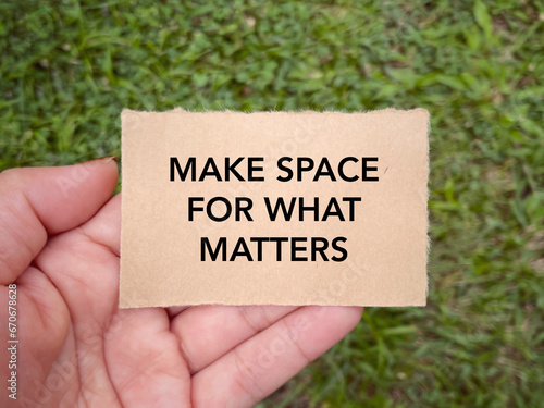 Motivational and inspirational wording. MAKE SPACE FOR WHAT MATTERS written on a paper. With blurred styled background.