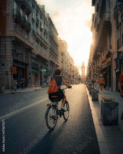 CYCLIST IN THE CITY AT SUNSET