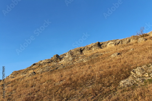 A hill with a hill and blue sky