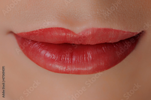 Tattoo permanent makeup on red lips woman