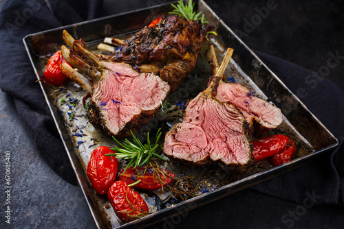 Traditional grilled rack of lamb with paprika and herbs served as close-up on a rustic metal tray