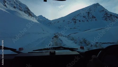 Traversing the Shinkula Pass in the White Mountains, shrouded in a blanket of snow, providing a breathtaking winter journey through the serene, snow-capped peaks and pristine landscapes. photo