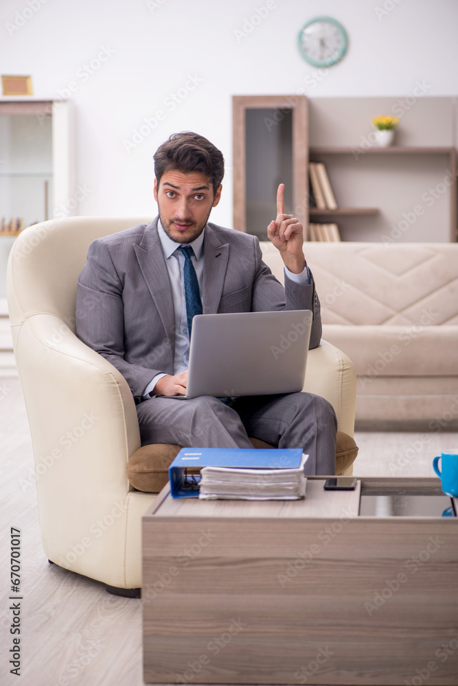 Young male employee working from home Young male employee working from home