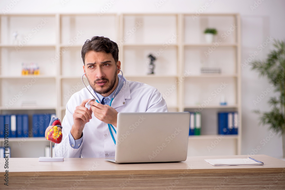 Young male doctor cardiologist working in the clinic Young male doctor cardiologist working in the clinic